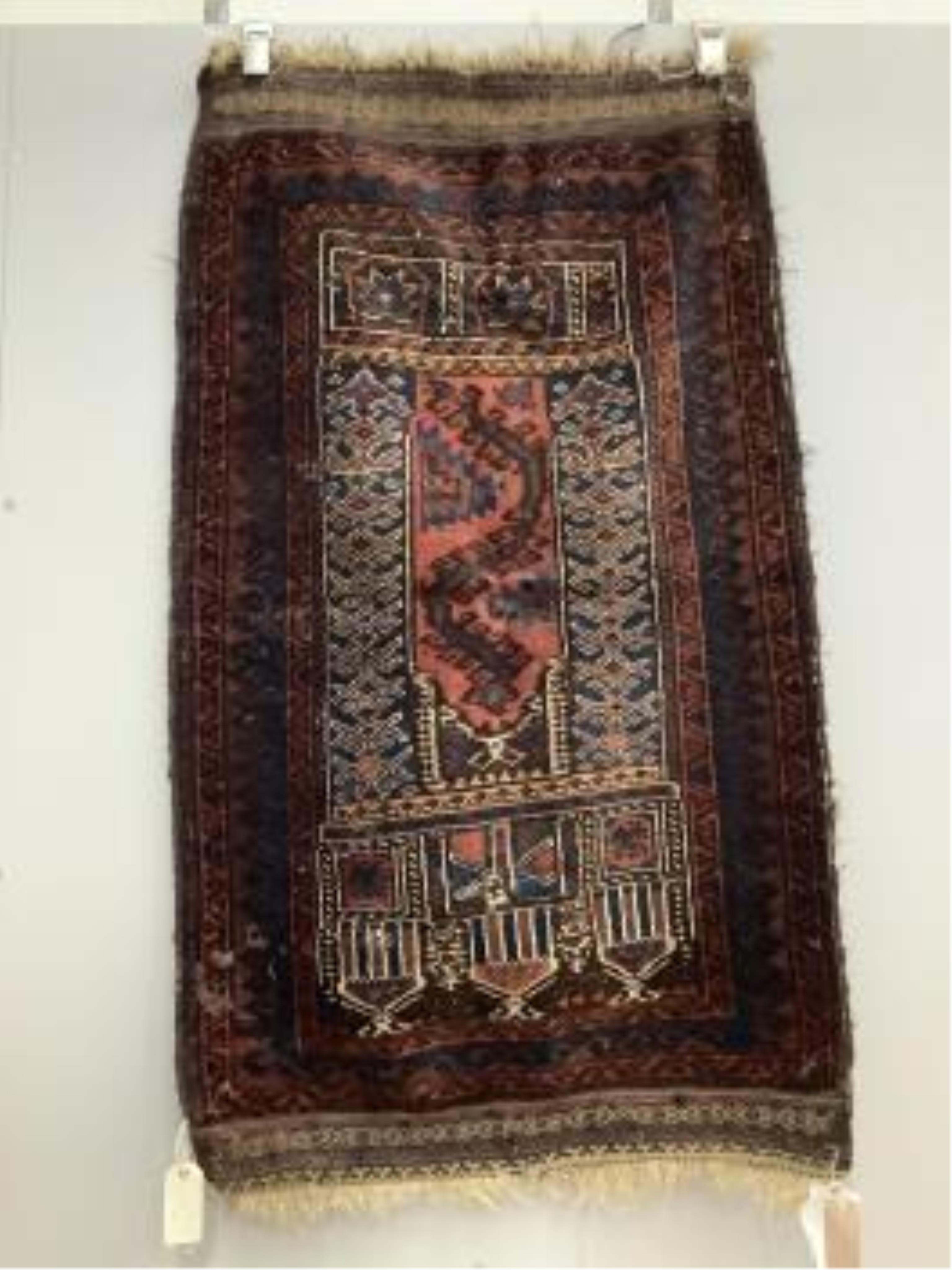 An antique Caucasian geometric rug, 250 x 140cm, together with a Belouch prayer rug, 130 x 78cm. Condition - poor